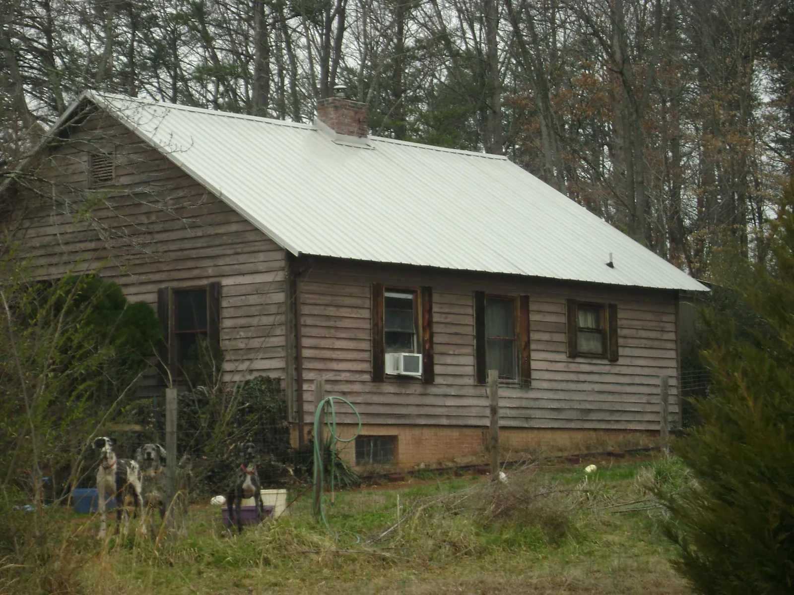 White metal roof on an old wood sided farmhouse, from a Metal Roof Installation job in Buena